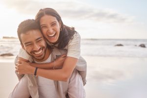 A happy, supportive couple on the beach